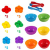 A set of colorful foam balls and plastic bowls with tweezers for sorting and counting toys.