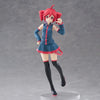 A PVC figure of Hatsune Miku with red hair wearing a blue outfit and black boots.