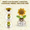 Handmade crochet sunflower pot doll with a yellow flower and green leaves, used as cheerful desk decor.
