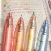 A set of four colorful fruit-scented gel pens with smooth writing tips shown on a notebook page.