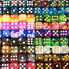 A collection of ten multi-colored acrylic D6 dice in various colors and patterns.