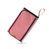 A pink portable baby changing mat with a storage bag and attached drawstring.