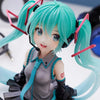 PVC figure of Hatsune Miku with teal hair and headphones, wearing a gray outfit.