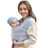 A woman is holding a baby in an ergonomic multi-functional baby sling carrier.