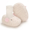 A pair of soft, light pink cartoon baby booties with a white cuff and a small pink ear detail.