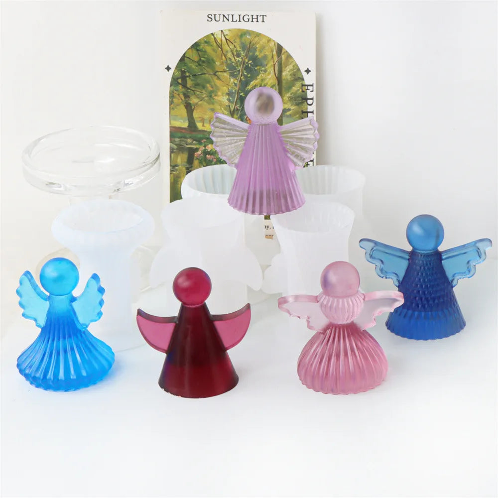 Silicone molds of cherub angels in various colors including pink purple blue and red for candles and soap making