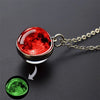 A pendant necklace featuring a red, glowing celestial body, with an inset showing a green celestial body.