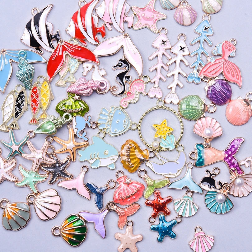 Assortment of gold-tone enamel charms featuring various shapes and colors for jewelry making