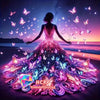 A woman stands facing a sunset with a vibrant diamond painting artwork of butterflies and floral designs spreading out like a
