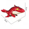 Red dinosaur fidget toy with movable joints and a yellow eye, shown from above.