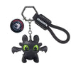 A black Toothless Dragon keychain featuring movable wings and glowing eyes.