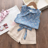A light blue floral chiffon sleeveless top and matching beige shorts set for a girl
