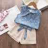 A light blue floral chiffon sleeveless top and matching shorts set for girls displayed on a wooden surface.
