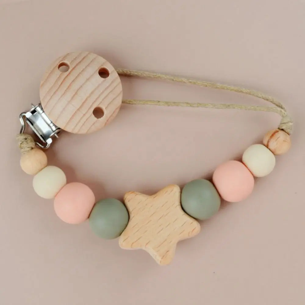 A wooden pacifier clip with silicone beads and a cord, featuring a star-shaped bead.