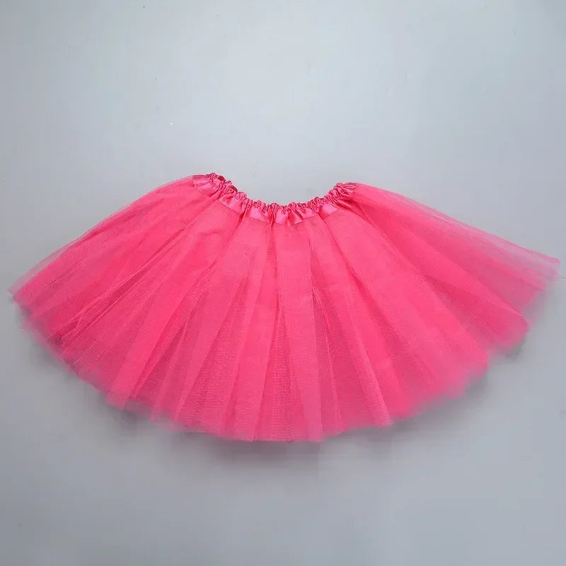 A bright pink three-layer tutu skirt for girls displayed flat.