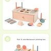 A wooden Montessori pitching box showing four different color and shape sorting activities.