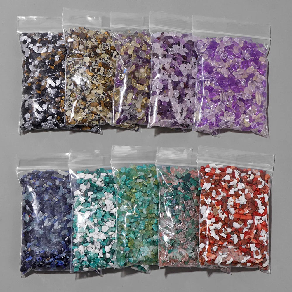 A collection of various colored natural tumbled stone chips packaged in clear plastic bags.