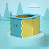 A foldable baby potty training seat in blue and yellow is shown floating on water with stylized mountains in the background.
