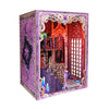 A decorative book nook kit featuring a gothic, ornate frame with stained glass and internal lighting elements.