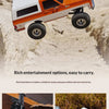 Orange and white 1:24 scale Chevrolet K5 Blazer RC crawler vehicle driving through muddy terrain.