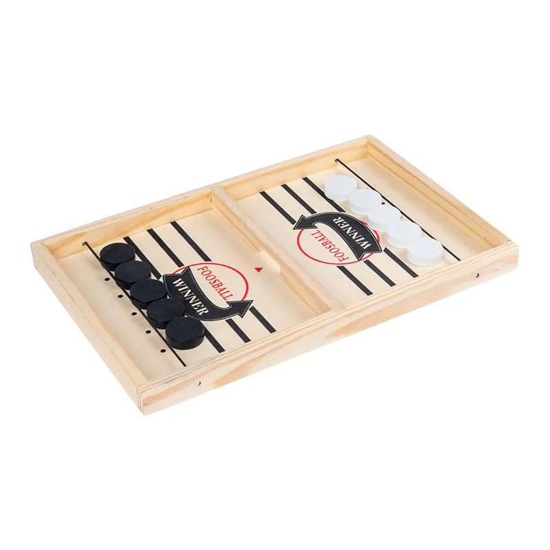 A wooden catapult tabletop hockey game with black and white pieces and a wooden playing surface.