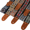 Embroidered guitar strap featuring various patterns on fabric with leather ends.