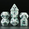 A set of white acrylic dice showing numbers 1 through 9 arranged in a pyramid formation.