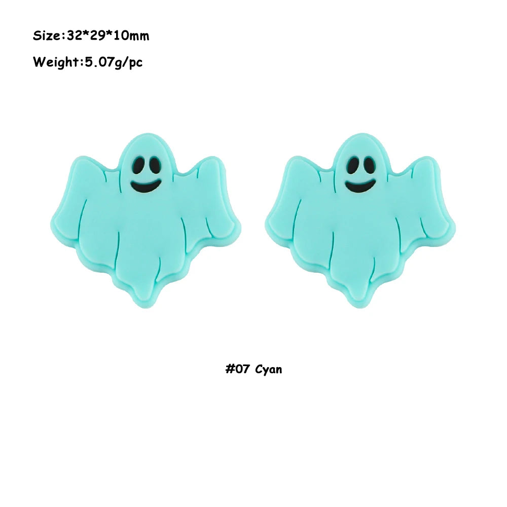 A pair of light blue silicone ghost-shaped beads for jewelry making.