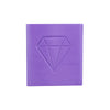 A square block of purple diamond painting clay with a diamond shape embossed on the top surface.