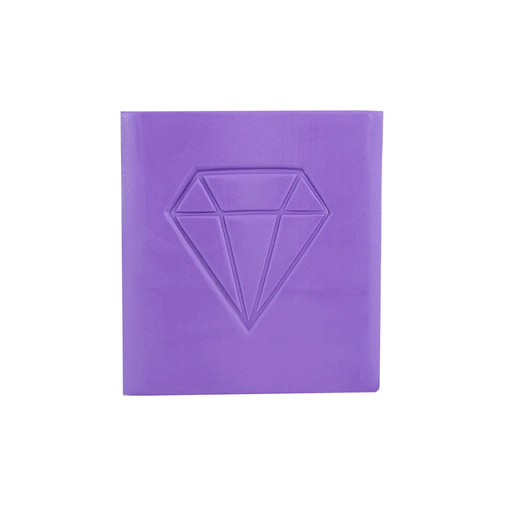 A square block of purple diamond painting clay with a diamond shape embossed on the top surface.