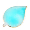 A translucent turquoise resin nail art palette with a gold trim.