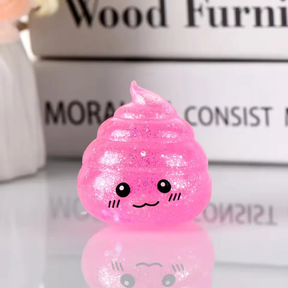 A bright pink glitter squishy stress ball shaped like a smiling face, resting on a reflective surface.