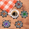 A collection of nine DIY diamond art coasters featuring various spider web designs in black, orange, white, and green.