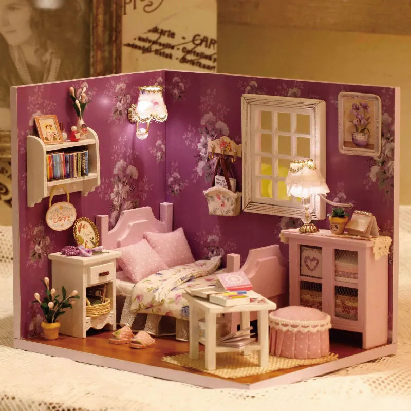 A detailed wooden miniature dollhouse kit featuring pink and white furniture, including a bed, cabinet, and window.