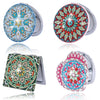 A folding mirror with a colorful, floral diamond art design on the cover and silver casing.
