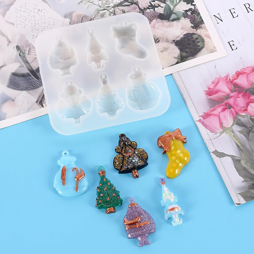 A silicone mold tray containing various festive Christmas-themed shapes for jewelry and craft projects.