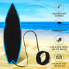 A black surfboard toy with a black elastic cord and an orange blue background, shown on a sandy beach.