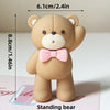 A standing bear figure with a pink bow, measuring 8.8cm tall.