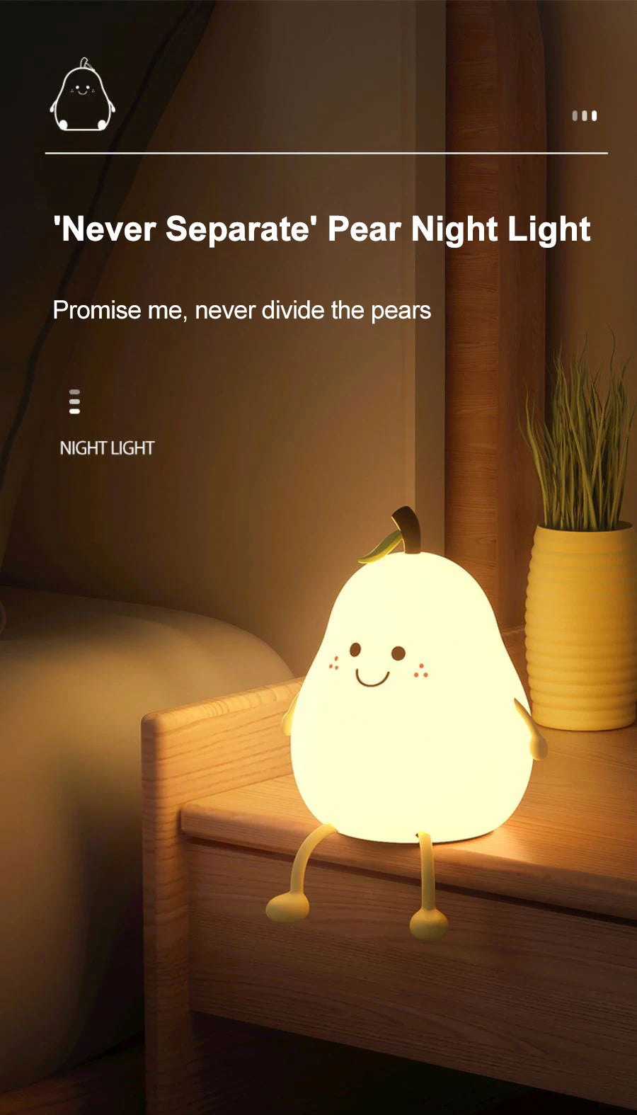 A glowing pear-shaped night light rests on a wooden surface next to a potted plant.