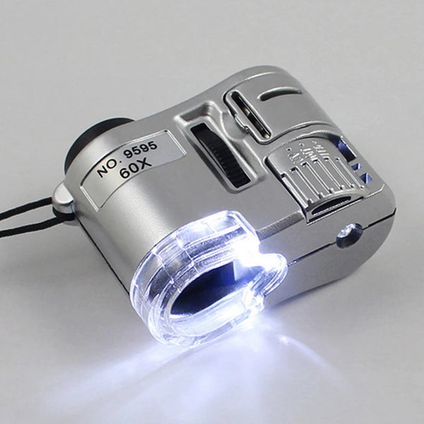 Silver handheld magnifying glass with an LED light, showing a bright beam.