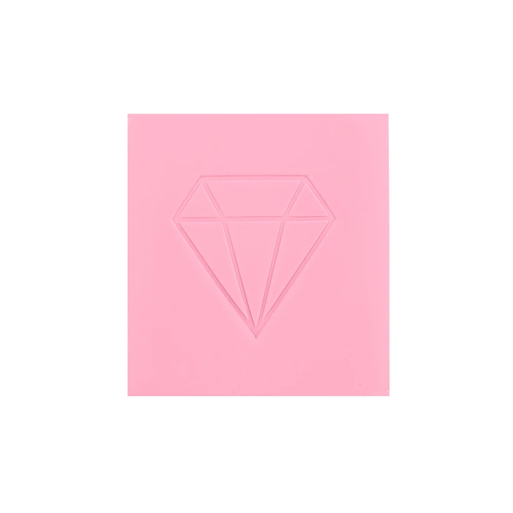 A square pink block with a diamond shape embossed on the surface, used as reusable wax for diamond painting.