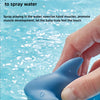 A hand is squeezing a blue water squirting turtle toy into water.
