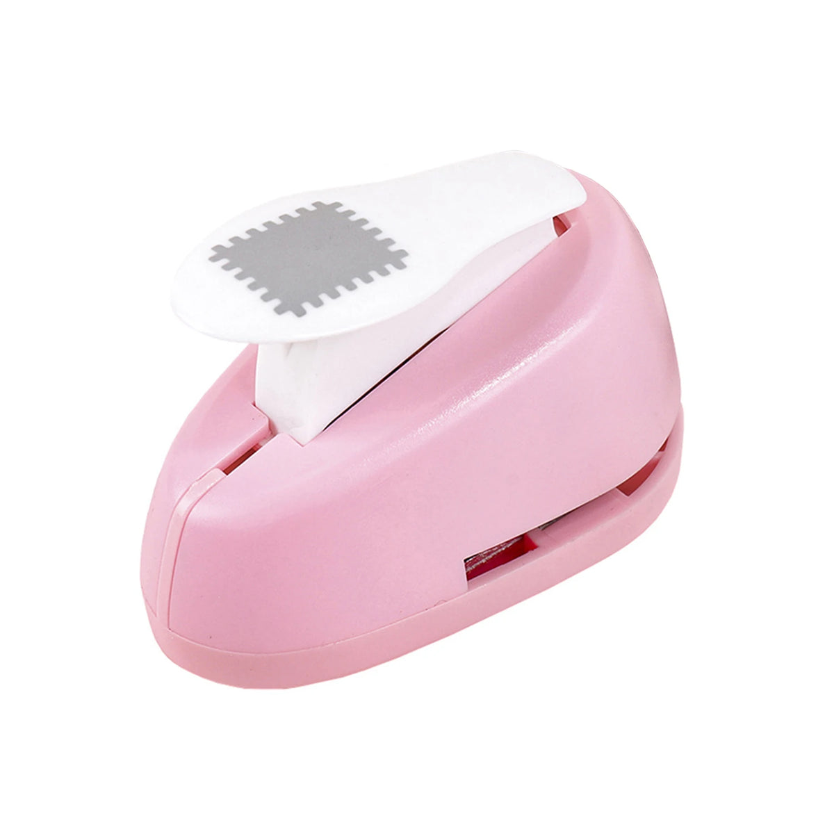 A pink lever action embosser tool with a white plate and a textured stamp
