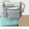 A gray portable stroller bag with hanging hooks is shown attached to a stroller bar.