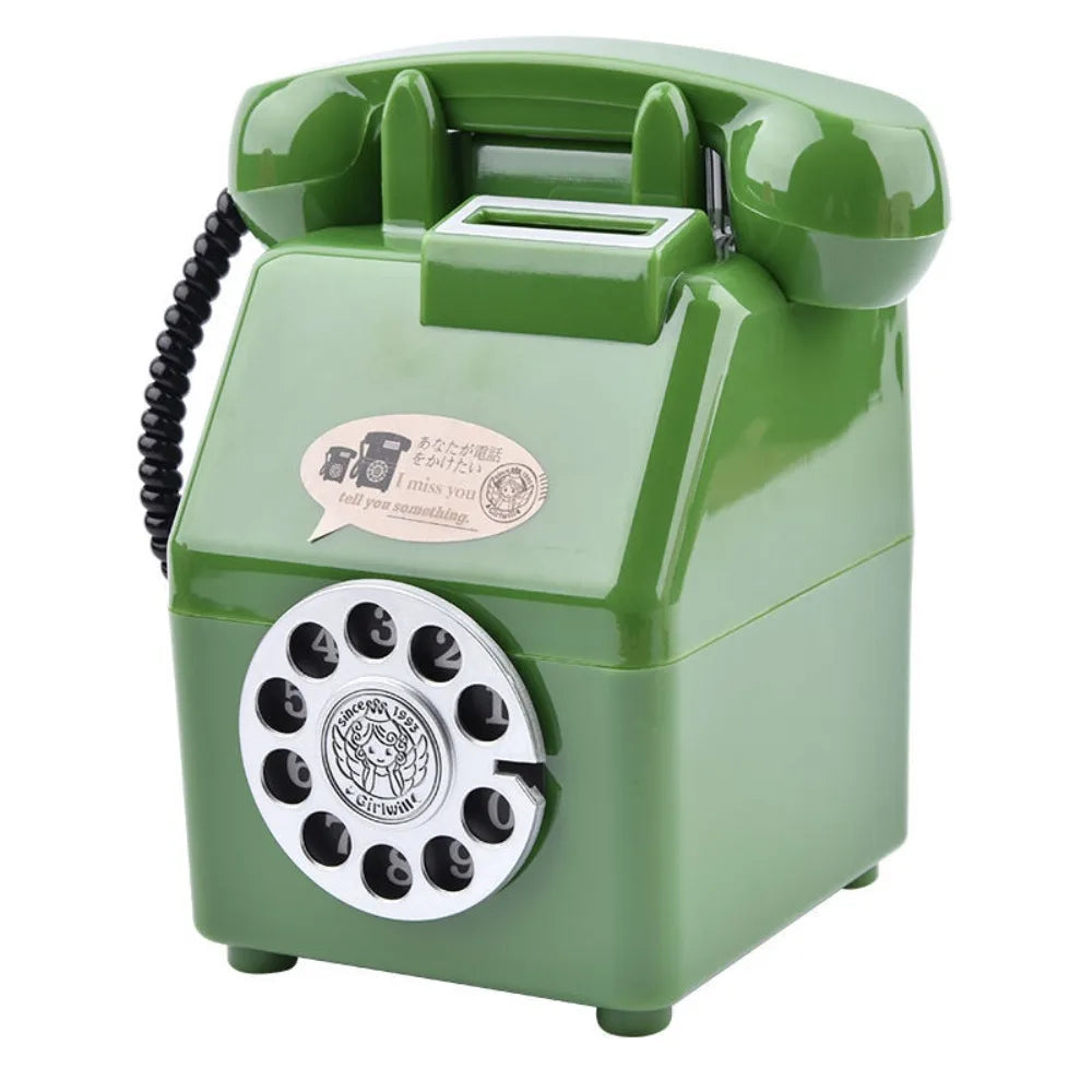 A vintage rotary telephone piggy bank in a light green color with a coin slot and a decorative emblem.