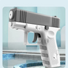 A white high-pressure water blaster gun is shown in a close-up, resting near a tiled pool.