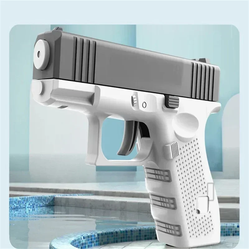 A white high-pressure water blaster gun is shown in a close-up, resting near a tiled pool.