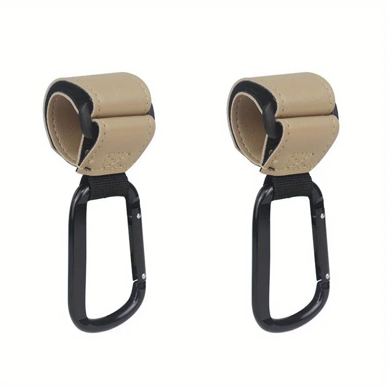 A pair of heavy-duty black and beige stroller hooks for hands-free organization.