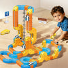 A child is playing with a colorful magnetic 3D cube train set featuring flexible tracks and various components on a wooden fl