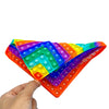 A hand holds a colorful, translucent fidget toy shaped like a diamond with multiple colored silicone balls.